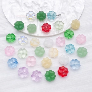 Macro shot of colorful glass clover spacer beads for DIY jewelry bracelets and necklaces