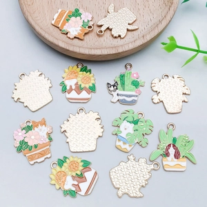 Detail view of colorful enamel pet and plant pendants with golden metallic back side