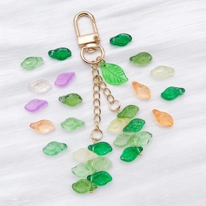 Detailed macro view of colorful translucent leaf pendants with gold metal keychain link