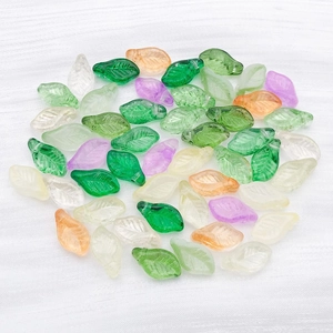 Detailed macro of colorful translucent leaf-shaped glass beads for DIY jewelry making