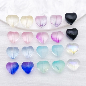 Detailed view of colorful heart-shaped glass beads for DIY jewelry and necklace making