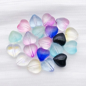 Close-up of colorful heart-shaped glass beads with pre-drilled holes for DIY jewelry