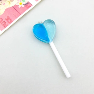 Detailed view of a heart-shaped resin lollipop pendant with blue glitter and silver ring