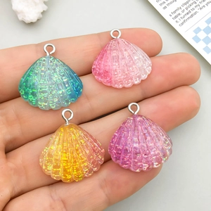 Macro detail of glitter resin shell charms with silver loops in various gradient colors