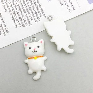 Detailed view of white resin cartoon cat pendant with orange collar and silver metal loop