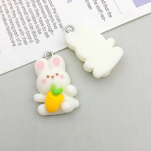 Detail of resin cartoon white rabbit charm holding carrot with top metal hanging loop