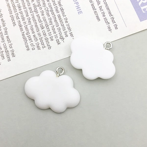 Detail of cloud-shaped resin charms with silver metal rings for DIY jewelry projects