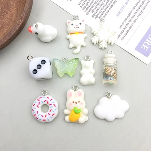 Detailed view of DIY resin animal charms set with silver hooks for jewelry making