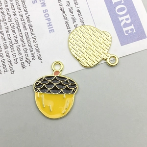 Detailed front and back views of enamel acorn charms for DIY jewelry making