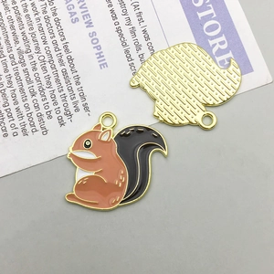 Detail of enamel squirrel pendants with gold plating and textured back for DIY jewelry