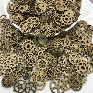 Close-up of vintage steampunk alloy gears and mechanical charms in a white ceramic bowl