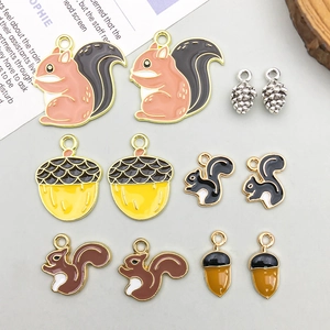 Flat lay of colorful squirrel and acorn enamel charms for DIY jewelry making
