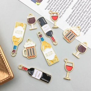 Detail of assorted wine and beer bottle pendants with colorful enamel finish for DIY jewelry