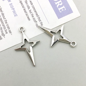 Detailed close-up of hollow silver star charms for DIY jewelry making accessories