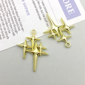 Macro detail of golden starburst alloy charms for DIY jewelry making accessories