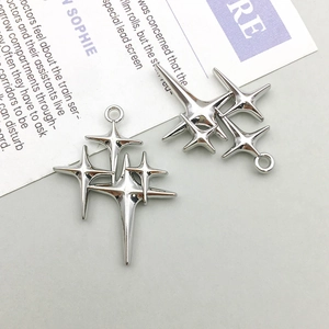 Macro detail of silver four-pointed star link pendant for DIY jewelry making
