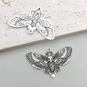 Detailed view of vintage gothic moth pendant with skull motif and intricate wing textures