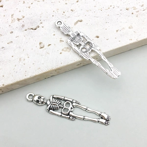 Detailed macro of vintage silver skull pendant with realistic skeletal texture and top loop