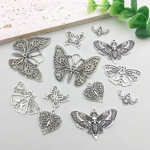 Macro view of vintage silver gothic butterfly and skull moth pendants for DIY jewelry