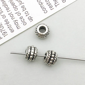 Macro shot of vintage silver alloy large hole spacer beads with rope texture for DIY jewelry