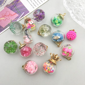 Colorful glass ball pendants with dried flowers and fruit slices for DIY jewelry