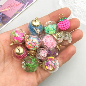 Mini glass bottle pendants with colorful dried flowers and fruit slices for DIY jewelry