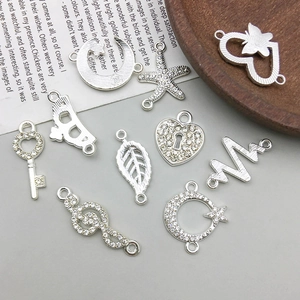 Detailansicht der silbernen Mond- und Herzanhänger mit Strass für DIY Schmuckdesign
