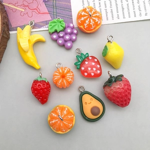 Detailed view of colorful 3D resin fruit charms with metal rings for DIY jewelry making