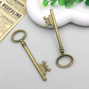 Detail view of two vintage bronze alloy key pendants for DIY jewelry making and crafts