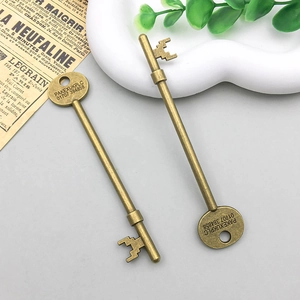 Detail of vintage bronze alloy key pendant with engraved serial numbers for DIY crafts