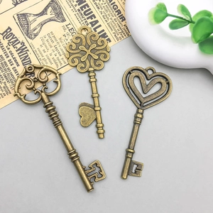 Three vintage bronze alloy keys with ornate floral and heart-shaped patterns for DIY crafts