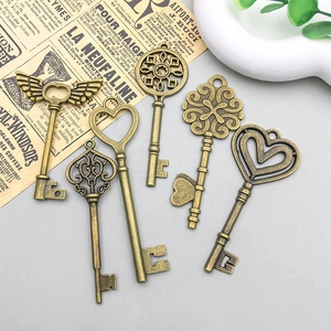 Set of 6 vintage bronze alloy key charms with intricate heart and wing details for DIY crafts