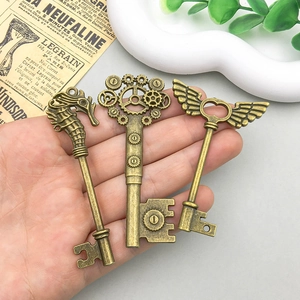 Three vintage bronze alloy charms in seahorse, gear, and winged heart styles for DIY jewelry