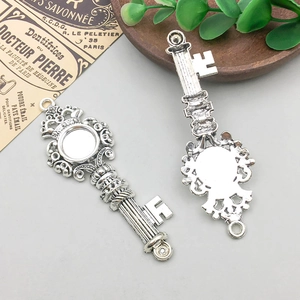 Detailed view of crown antique silver key charms with round base for DIY jewelry making