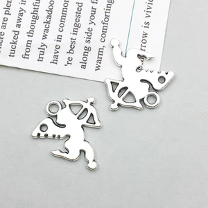 Detail shot of antique silver cupid charms with bow and wings for DIY jewelry making