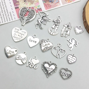 Detailed collection of 18 antique silver alloy heart pendants with romantic engravings