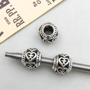 Macro shot of antique silver hollow heart charms for DIY jewelry making sets