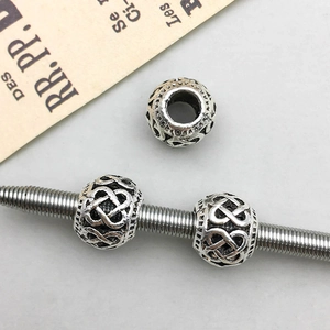 Macro detail of antique silver Celtic knot hollow beads for DIY jewelry making