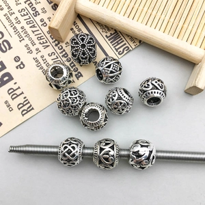 Detailed view of antique silver hollow heart and flower large hole beads for DIY crafts