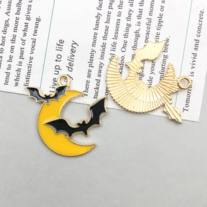 Detailed front and back view of a yellow enamel crescent moon and black bat charm