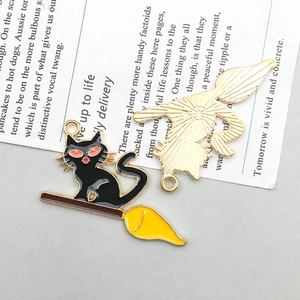 Front and back detail of Halloween black cat on broom enamel charms for DIY jewelry
