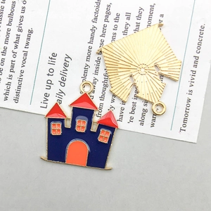 Detail of colorful enamel castle charms with golden backing for DIY jewelry making