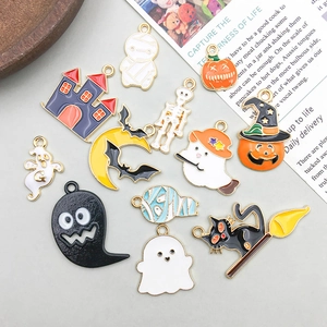 Flat lay of colorful Halloween oil-drip alloy charms including pumpkins and ghosts