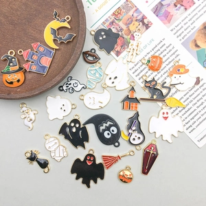 Detailed close-up of colorful Halloween enamel charms on vintage magazine and wood