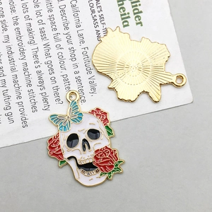 Detail of gothic skull pendant showing colorful enamel front and gold textured back
