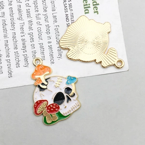 Detail of colorful skull and mushroom alloy charm with golden metallic back for DIY jewelry