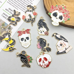 Macro detail of Gothic Halloween pendants with skeleton, raven and snake designs
