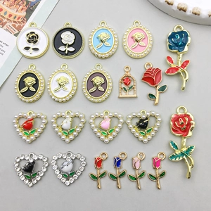 Flat lay of colorful enamel rose flower alloy heart pendants for DIY jewelry making