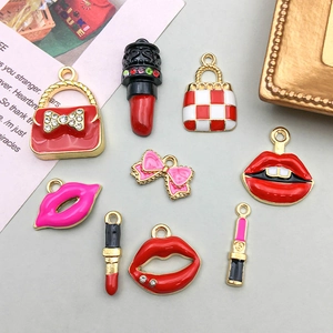 Flat lay of red enamel lipstick and handbag charms for DIY jewelry making kits