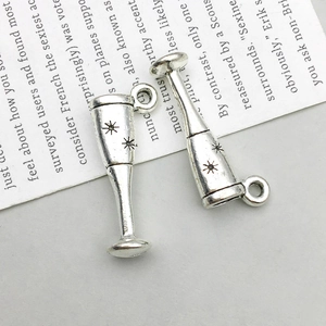 Detail of antique silver wine glass charms with star engraving for DIY jewelry making